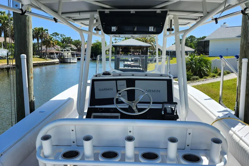 Slide: The Image of 2001 Jupiter 31 Open Center Console boat docked by a canal, featuring Garmin navigation. - 6