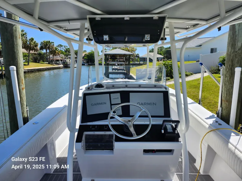 Slide: The Image of 2001 Jupiter 31 Open Center Console boat with Garmin navigation, docked in a scenic canal. - 7