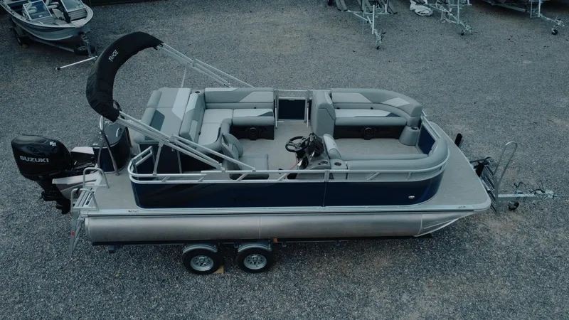 Slide: The Image of 2025 Tahoe Pontoon Sport 85 Cruise boat on trailer, featuring spacious seating and sleek design. - 1