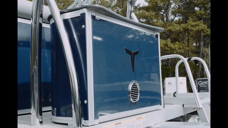 Slide: The Image of 2025 Tahoe Pontoon Sport 85 Cruise, blue paneling, outdoor setting, sleek design. - 12