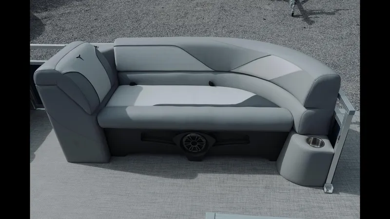 Slide: The Image of 2025 Tahoe Pontoon Sport 85 Cruise, featuring sleek gray seating with integrated speaker and cup holder. - 22
