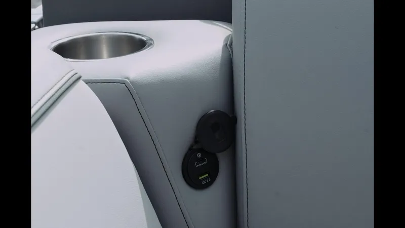 Slide: The Image of 2025 Tahoe Pontoon Sport 85 Cruise interior with cup holder and USB port. - 23
