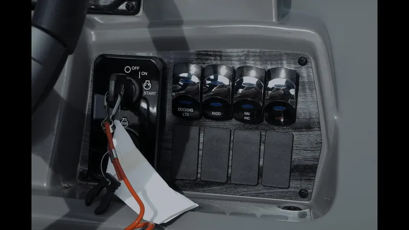 Slide: The Image of Control panel of 2025 Tahoe Pontoon Sport 85 Cruise with ignition and switches. - 6