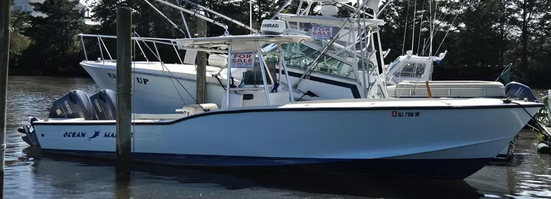 Slide: The Image of 1988 Ocean Master 31 Center Console boat docked, with "For Sale" signs visible. - 11
