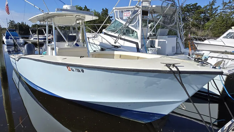 Slide: The Image of 1988 Ocean Master 31 Center Console boat docked, with "For Sale" sign visible. - 7