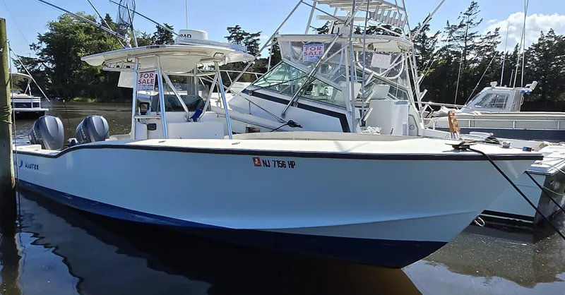 Slide: The Image of 1988 Ocean Master 31 Center Console boat docked, featuring dual outboard motors. - 9