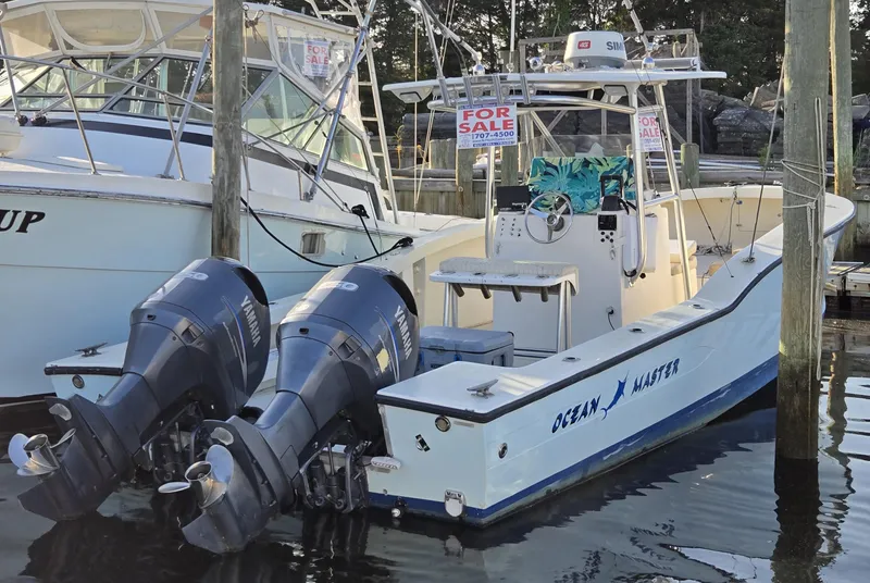The Image of 1988 Ocean Master 31 Center Console boat with twin engines, docked and for sale. - 0