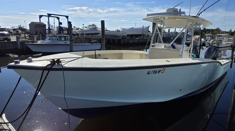 Slide: The Image of 1988 Ocean Master 31 Center Console boat docked in a marina. - 10