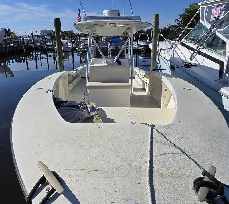 Slide: The Image of 1988 Ocean Master 31 Center Console boat docked at marina. - 12