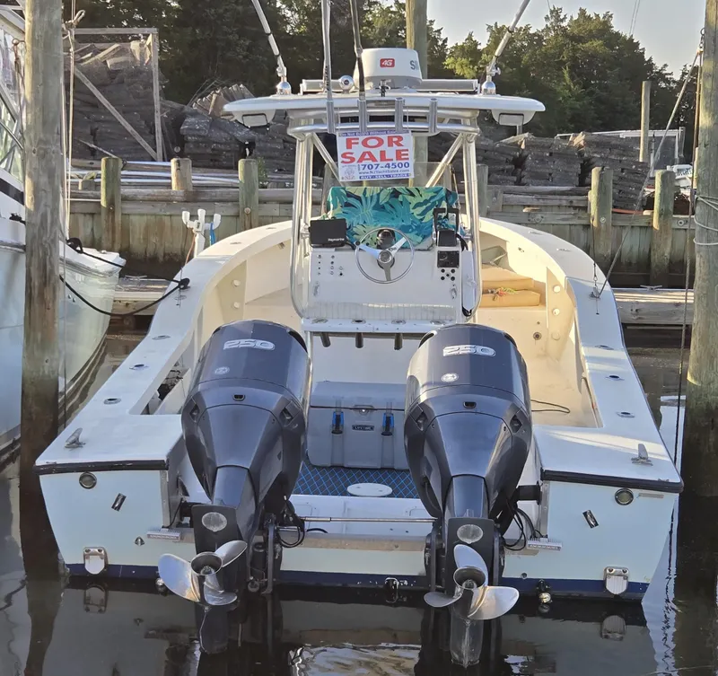 Slide: The Image of 1988 Ocean Master 31 Center Console boat for sale, docked with dual outboard engines. - 4