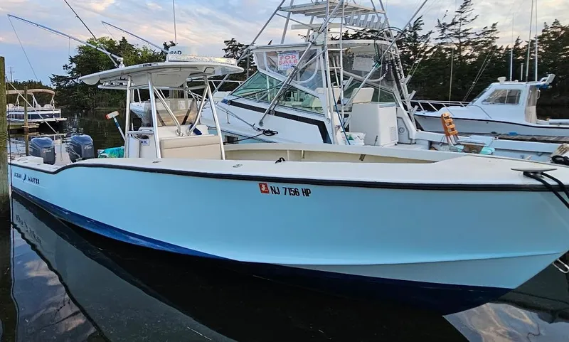 Slide: The Image of 1988 Ocean Master 31 Center Console boat docked in a marina. - 6