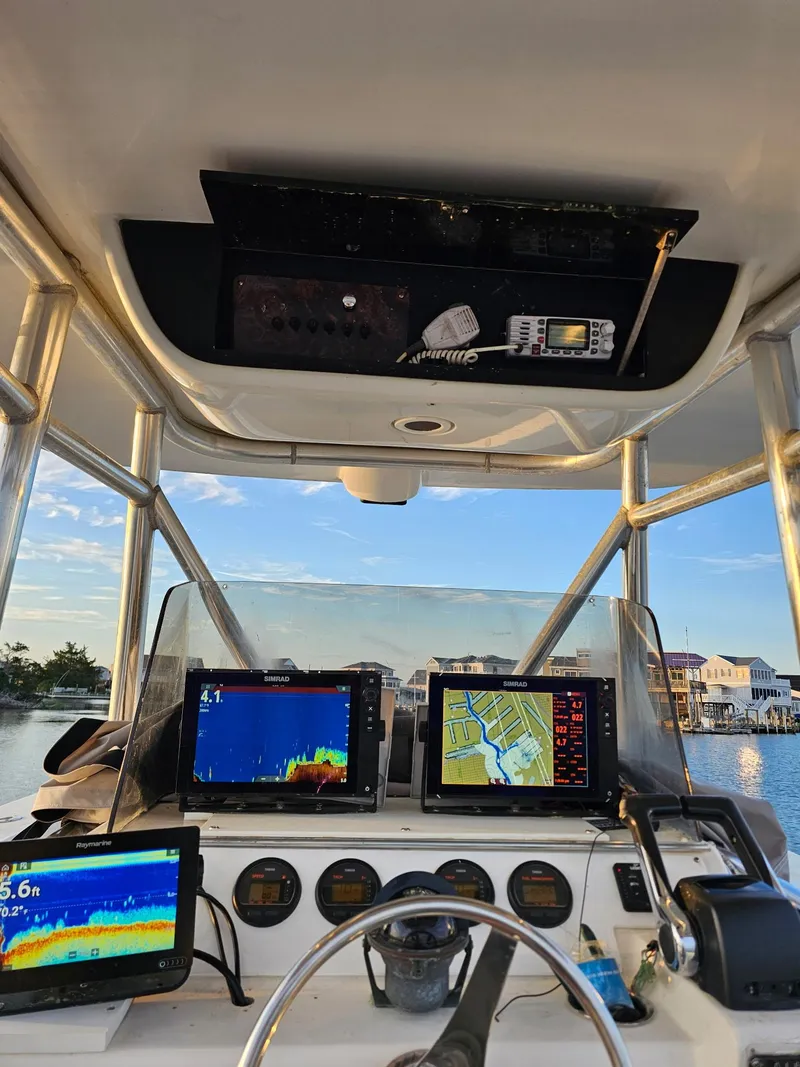 Slide: The Image of 1988 Ocean Master 31 Center Console boat cockpit with navigation equipment and scenic water view. - 8
