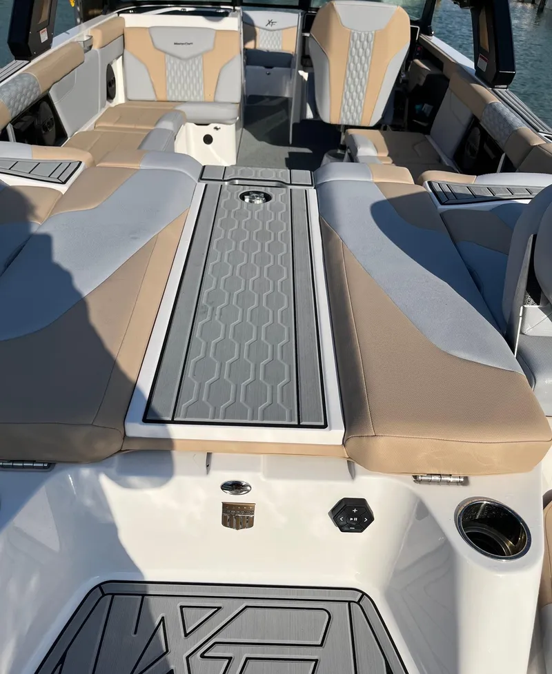 Slide: The Image of 2025 MasterCraft XT24 boat interior with beige and gray seating, featuring modern design elements. - 4