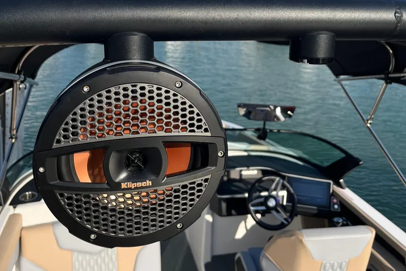 Slide: The Image of 2025 MasterCraft XT24 boat with Klipsch speaker, featuring modern interior and steering console. - 6
