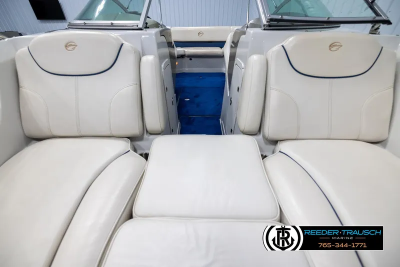 Slide: The Image of 2006 Crownline 230 LS boat interior with white leather seating and blue carpet. - 16