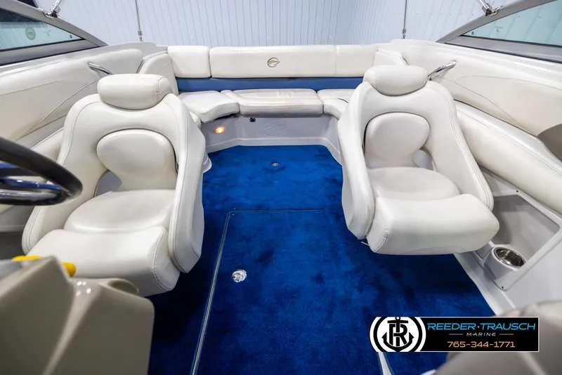 Slide: The Image of 2006 Crownline 230 LS boat interior with white seating and blue carpet. - 17