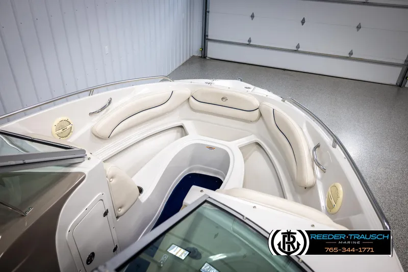 Slide: The Image of 2006 Crownline 230 LS boat interior with white seating and storage compartments. - 21