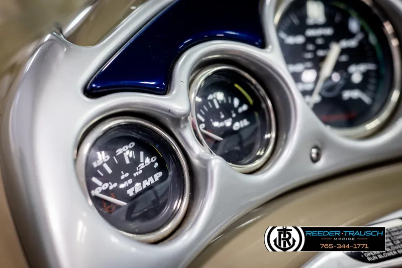 Slide: The Image of Dashboard gauges of a 2006 Crownline 230 LS boat, showing temperature and oil indicators. - 28