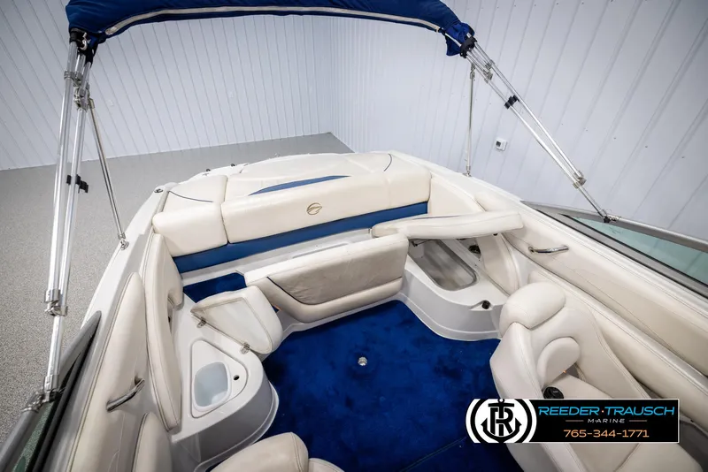 Slide: The Image of 2006 Crownline 230 LS boat interior with blue and white seating and canopy. - 46