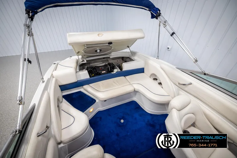 Slide: The Image of 2006 Crownline 230 LS boat interior with blue carpet and white seating. - 47
