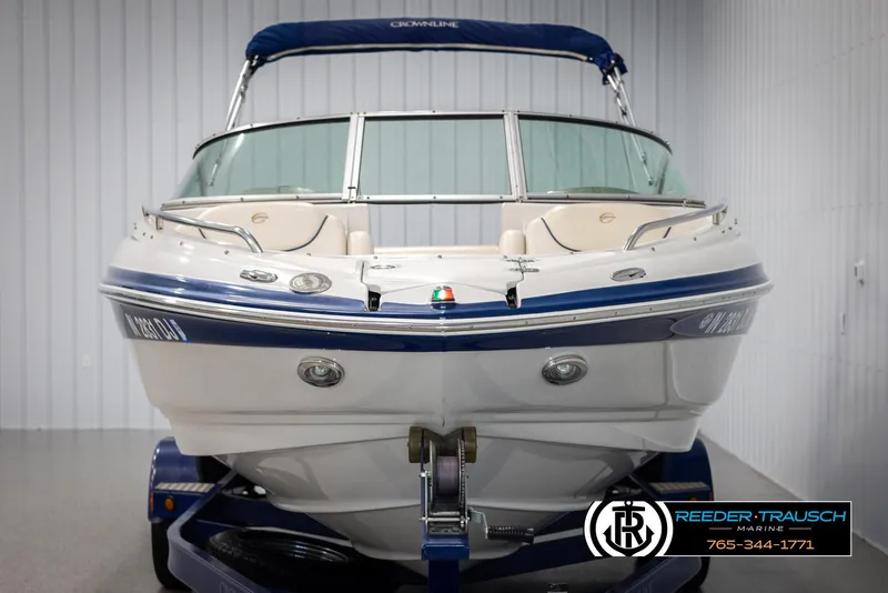 Slide: The Image of 2006 Crownline 230 LS boat with blue accents in a showroom. - 8