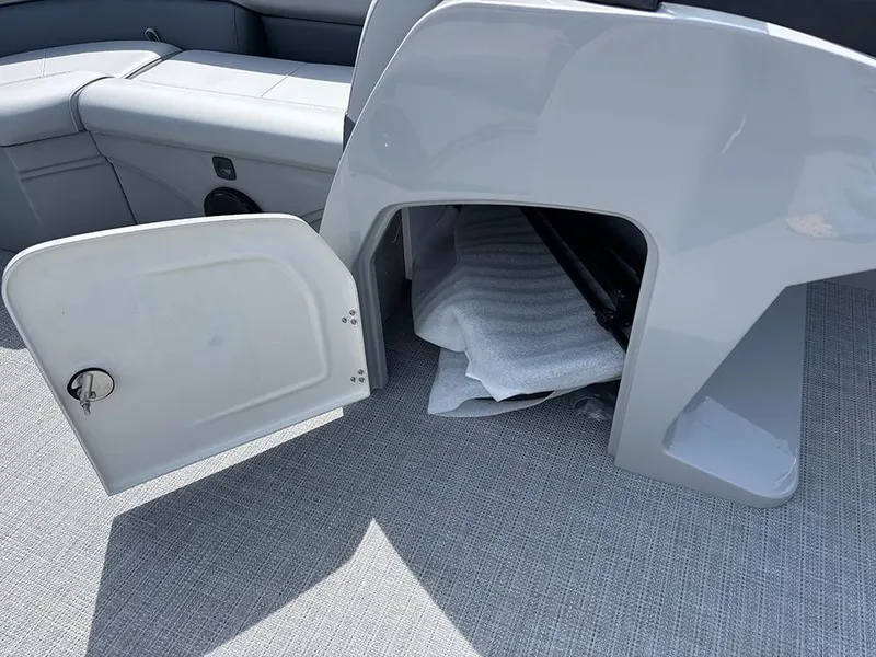 Slide: The Image of 2025 Bentley Pontoons Legacy QSB storage compartment with open door on a boat. - 16