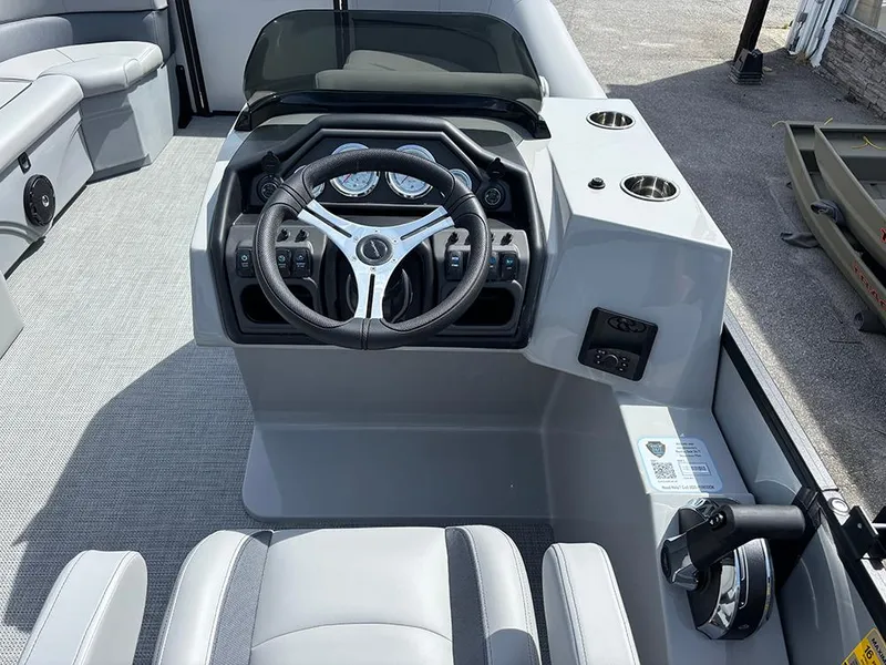 Slide: The Image of 2025 Bentley Pontoons Legacy QSB dashboard with steering wheel and controls, featuring modern design. - 17