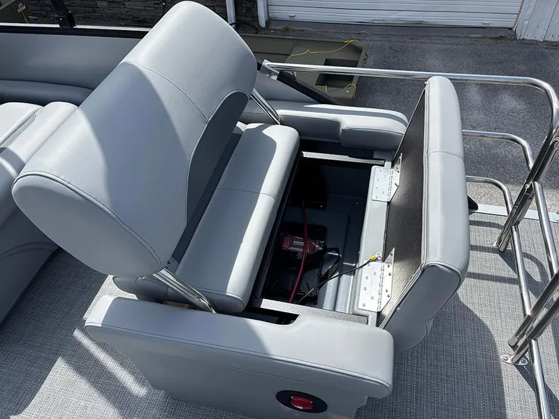 Slide: The Image of 2025 Bentley Pontoons Legacy QSB with open storage compartment under gray seating. - 22