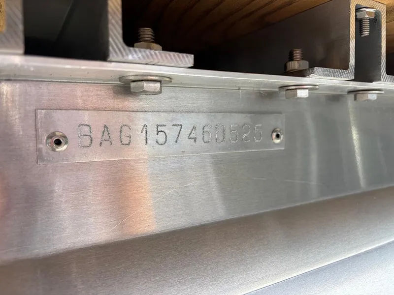 Slide: The Image of 2025 Bentley Pontoons Legacy QSB serial number plate on metal surface. - 25