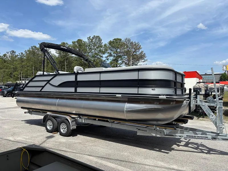 Slide: The Image of 2025 Bentley Pontoons Legacy QSB on trailer, parked outdoors under a clear sky. - 4