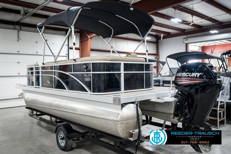 Slide: The Image of 2018 Bennington 20 SLMX pontoon boat with Mercury outboard motor in a showroom. - 10