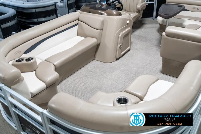 Slide: The Image of 2018 Bennington 20 SLMX pontoon boat interior with beige seating and cup holders. - 12