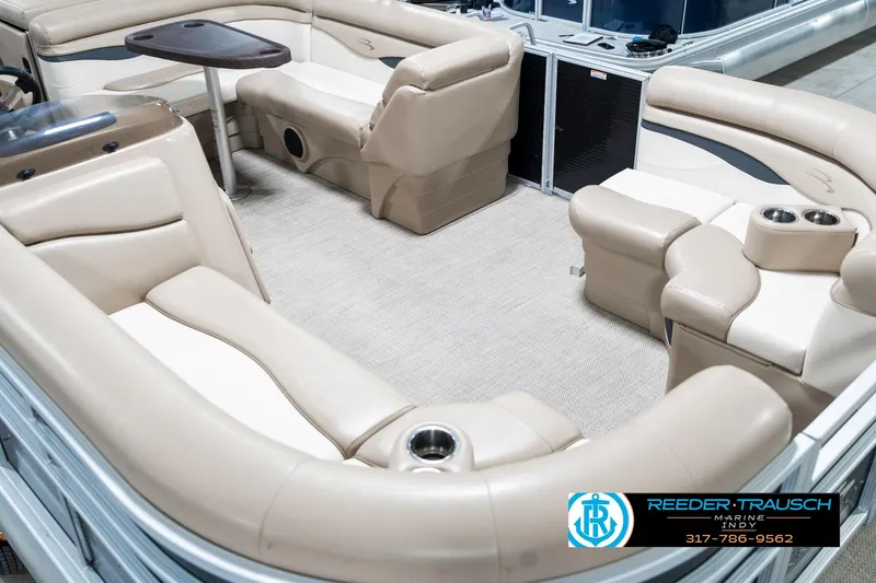 Slide: The Image of 2018 Bennington 20 SLMX pontoon boat interior with beige seating and table. - 13