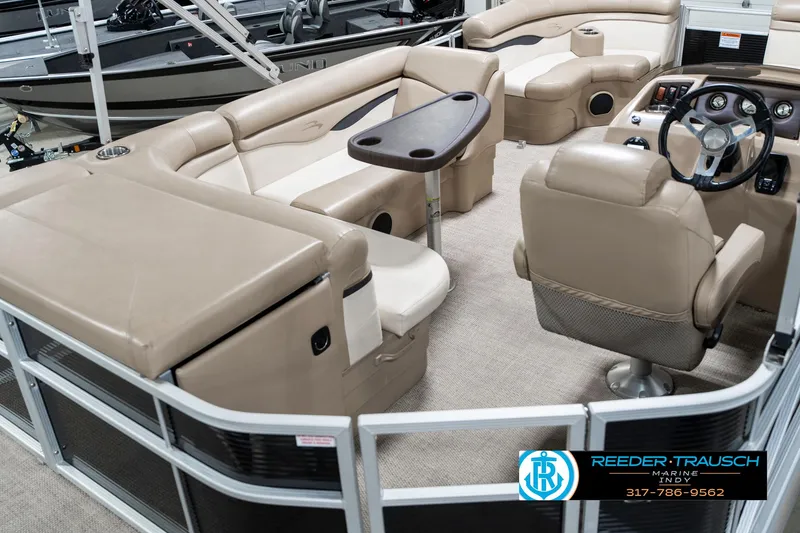 Slide: The Image of 2018 Bennington 20 SLMX pontoon boat interior with beige seating and steering console. - 14