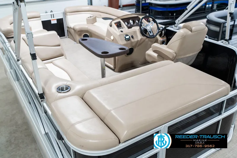 Slide: The Image of 2018 Bennington 20 SLMX pontoon boat interior with beige seating and steering console. - 15