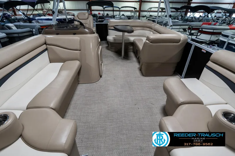 Slide: The Image of 2018 Bennington 20 SLMX pontoon boat interior with beige seating and carpeted floor. - 16