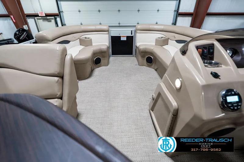 Slide: The Image of 2018 Bennington 20 SLMX pontoon boat interior with beige seating and modern dashboard. - 20