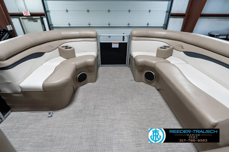 Slide: The Image of 2018 Bennington 20 SLMX pontoon boat interior with beige seating and cup holders. - 21