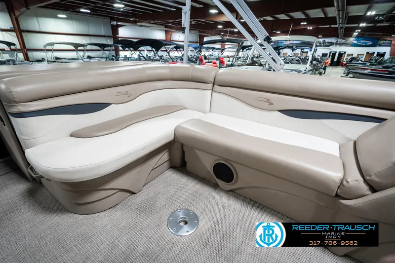 Slide: The Image of 2018 Bennington 20 SLMX pontoon boat interior with beige seating in showroom. - 27