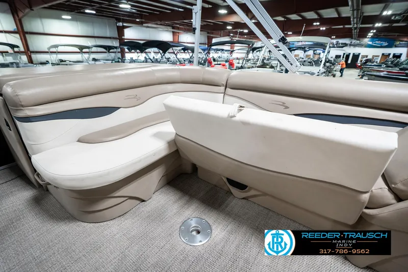 Slide: The Image of 2018 Bennington 20 SLMX pontoon boat interior with beige seating in showroom. - 28