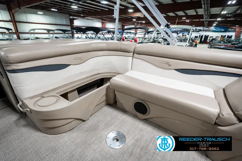 Slide: The Image of 2018 Bennington 20 SLMX pontoon boat interior with beige seating in showroom. - 29
