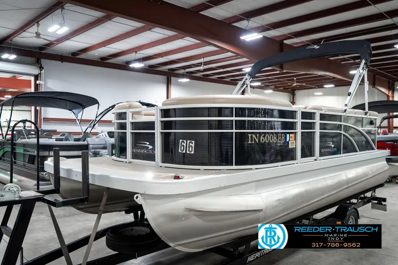Slide: The Image of 2018 Bennington 20 SLMX pontoon boat in showroom, featuring sleek design and modern amenities. - 3