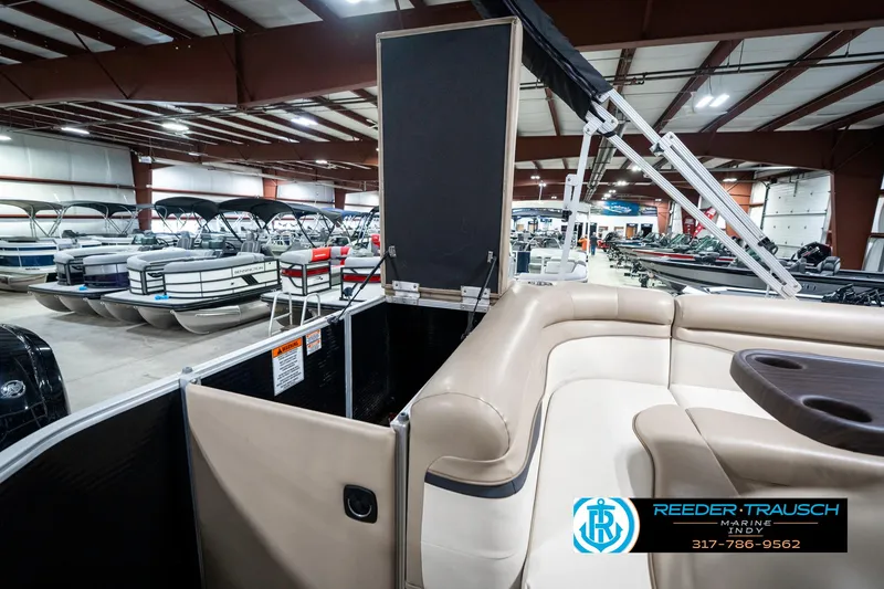 Slide: The Image of 2018 Bennington 20 SLMX pontoon boat interior in showroom with beige seating. - 31