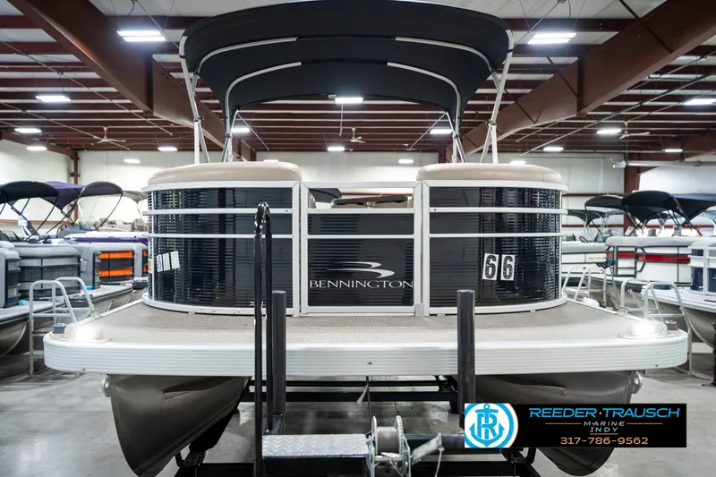 Slide: The Image of 2018 Bennington 20 SLMX pontoon boat displayed indoors at Reeder-Trausch Marine. - 5