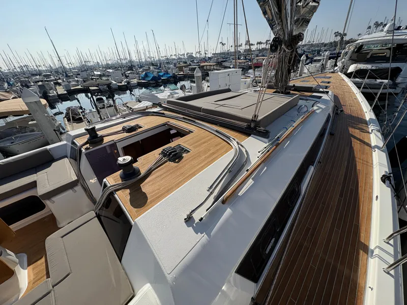Slide: The Image of 2018 Dufour 560 Exclusive yacht with sleek deck design in a marina setting. - 10