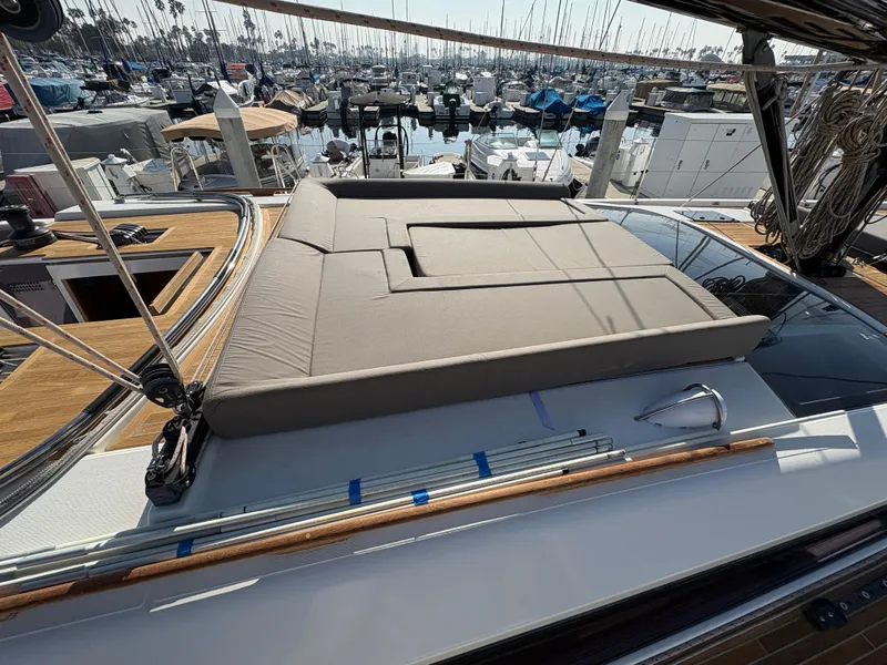 Slide: The Image of 2018 Dufour 560 Exclusive yacht with sunbed, docked in a marina. - 11