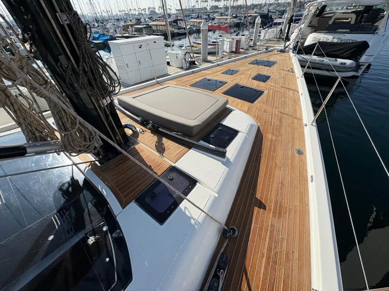 Slide: The Image of Dufour 560 Exclusive 2018 yacht deck with teak finish and marina view. - 12