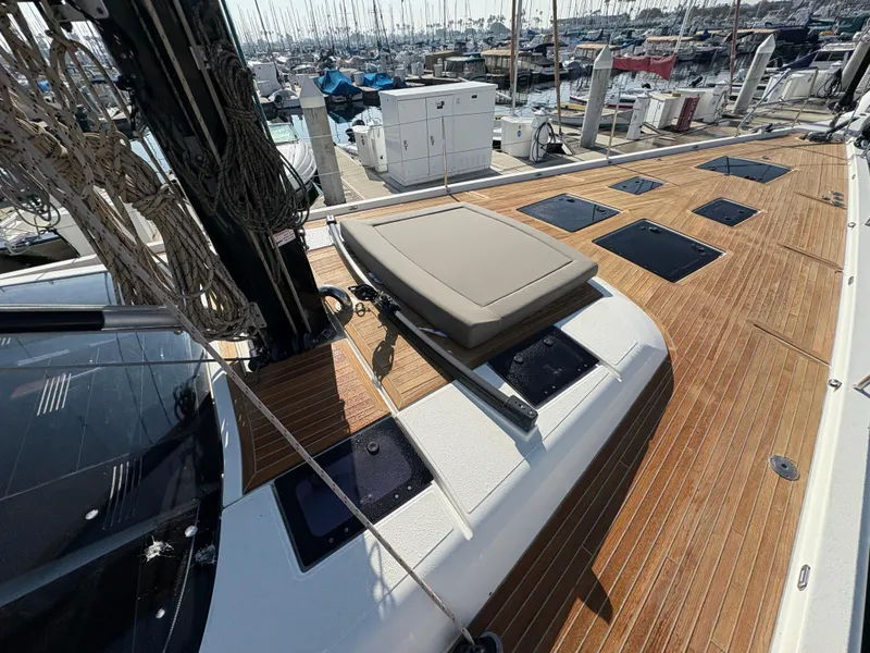 Slide: The Image of 2018 Dufour 560 Exclusive yacht deck with teak flooring and sunbathing area in marina. - 13