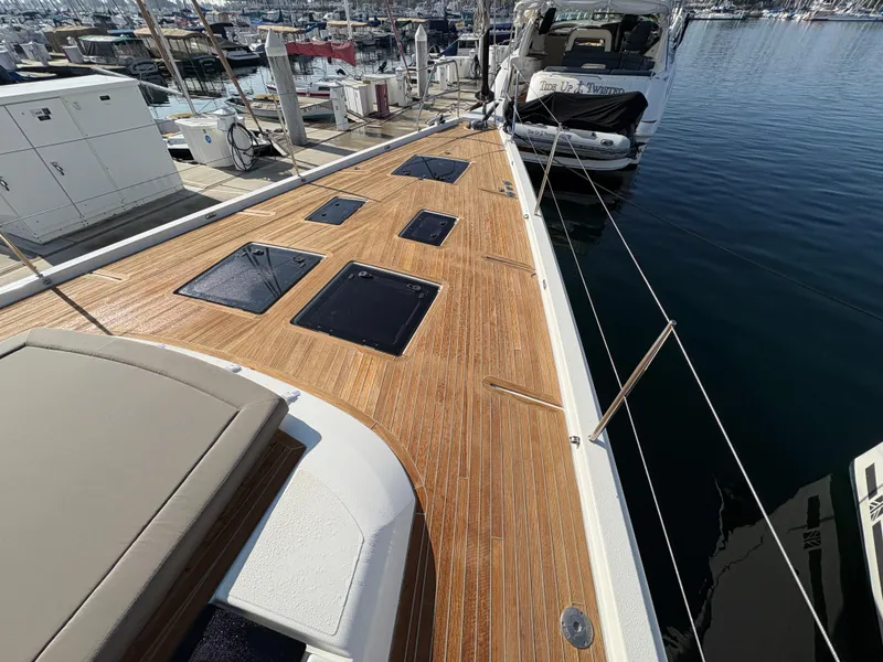 Slide: The Image of 2018 Dufour 560 Exclusive yacht with teak deck, docked at marina. - 15