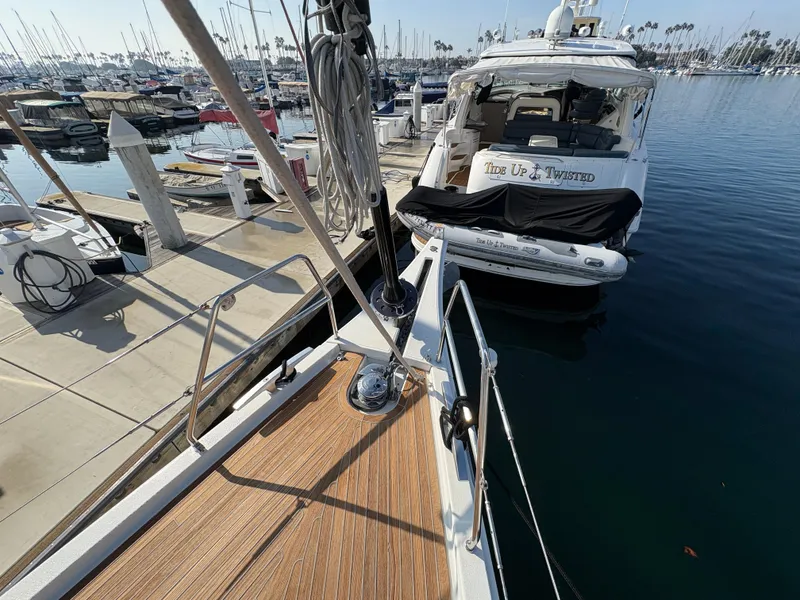 Slide: The Image of Dufour 560 Exclusive 2018 yacht docked at marina, with view of neighboring boat. - 16
